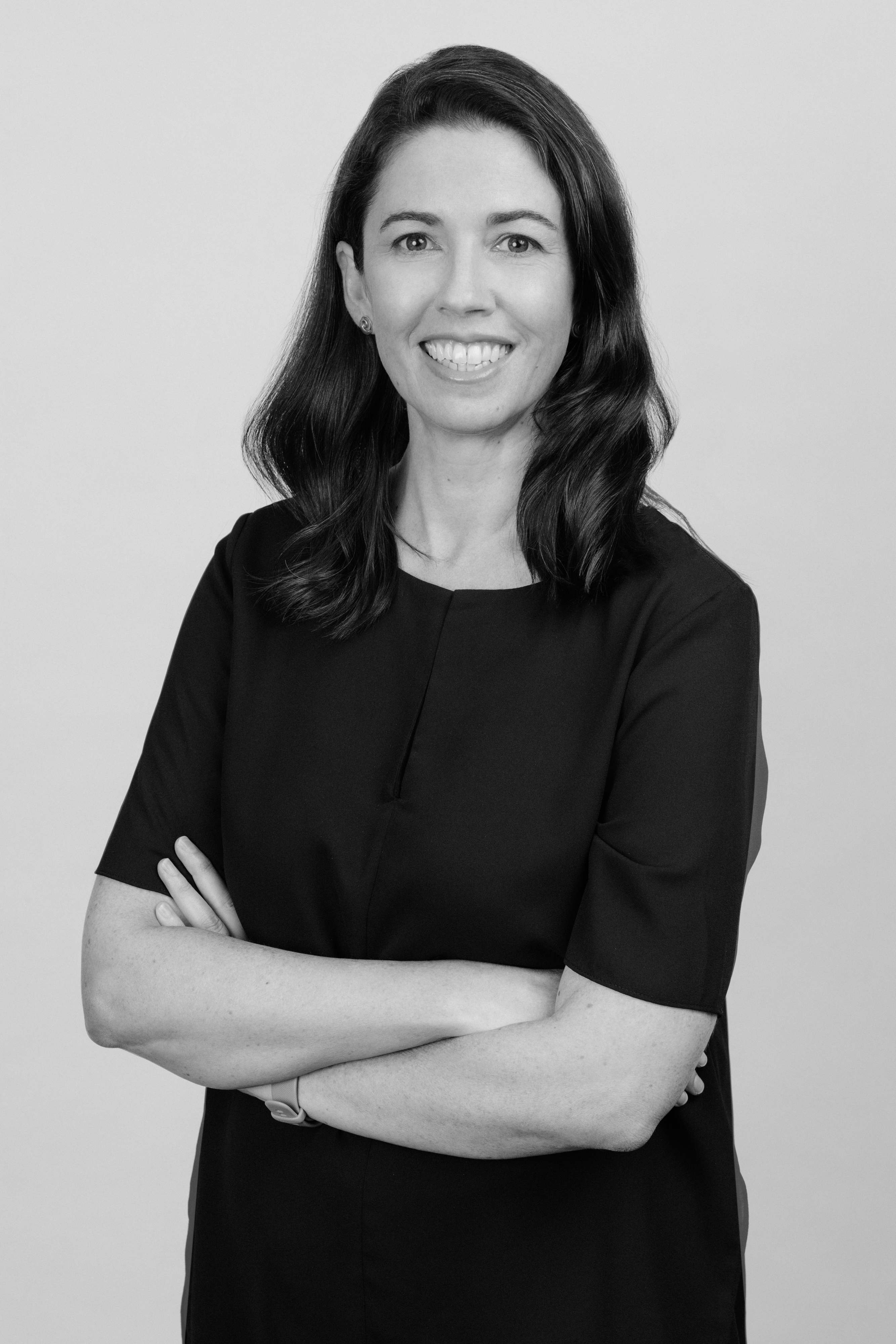 Headshot of Samantha Shuttleworth, smiling and wearing a black top